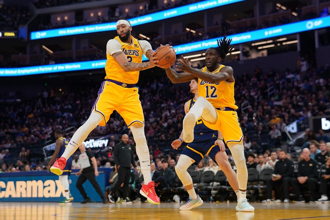 Feb 22, 2024; San Francisco, California, USA; Los Angeles Lakers forward Anthony Davis (3) holds onto a rebound next to forward Taurean Prince (12) against the Golden State Warriors in the third quarter at the Chase Center. Mandatory Credit: Cary Edmondson-USA TODAY Sports