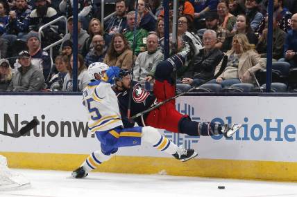 Feb 23, 2024; Columbus, Ohio, USA; Buffalo Sabres defenseman Connor Clifton (75) checks Columbus Blue Jackets center Sean Kuraly (7) during the first period at Nationwide Arena. Mandatory Credit: Russell LaBounty-USA TODAY Sports