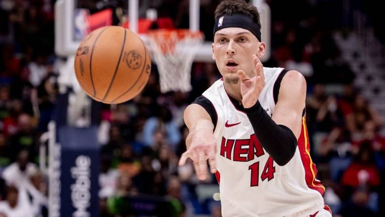 Feb 23, 2024; New Orleans, Louisiana, USA;  Miami Heat guard Tyler Herro (14) passes the ball against the New Orleans Pelicans during the first half at Smoothie King Center. Mandatory Credit: Stephen Lew-USA TODAY Sports