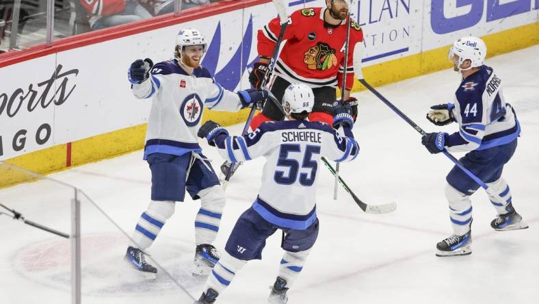 Feb 23, 2024; Chicago, Illinois, USA; Winnipeg Jets left wing Kyle Connor (81) celebrates with teammates after scoring a game winning goal against the Chicago Blackhawks during overtime at United Center. Mandatory Credit: Kamil Krzaczynski-USA TODAY Sports