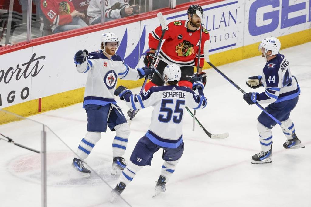 Feb 23, 2024; Chicago, Illinois, USA; Winnipeg Jets left wing Kyle Connor (81) celebrates with teammates after scoring a game winning goal against the Chicago Blackhawks during overtime at United Center. Mandatory Credit: Kamil Krzaczynski-USA TODAY Sports