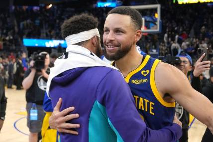 Feb 23, 2024; San Francisco, California, USA; Golden State Warriors guard Stephen Curry (right) hugs Charlotte Hornets guard Seth Curry (left) after the game at Chase Center. Mandatory Credit: Darren Yamashita-USA TODAY Sports