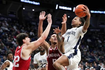 Feb 24, 2024; University Park, Pennsylvania, USA; Penn State Nittany Lions guard Ace Baldwin Jr (1) drives to the basket as Indiana Hoosiers guard Trey Galloway (32) defends during the first half at Bryce Jordan Center. Mandatory Credit: Matthew O'Haren-USA TODAY Sports