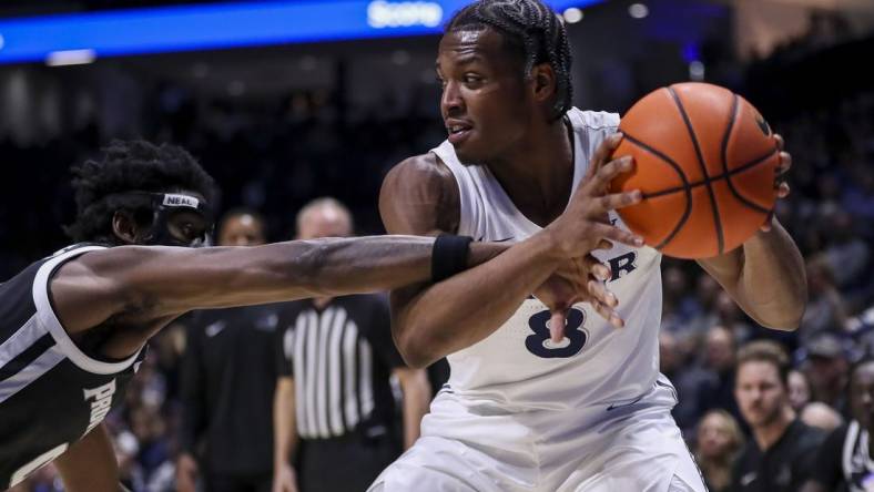 Feb 21, 2024; Cincinnati, Ohio, USA; Xavier Musketeers guard Quincy Olivari (8) holds the ball against Providence Friars guard Ticket Gaines (0) in the first half at Cintas Center. Mandatory Credit: Katie Stratman-USA TODAY Sports