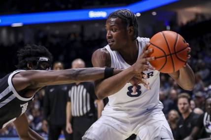 Feb 21, 2024; Cincinnati, Ohio, USA; Xavier Musketeers guard Quincy Olivari (8) holds the ball against Providence Friars guard Ticket Gaines (0) in the first half at Cintas Center. Mandatory Credit: Katie Stratman-USA TODAY Sports