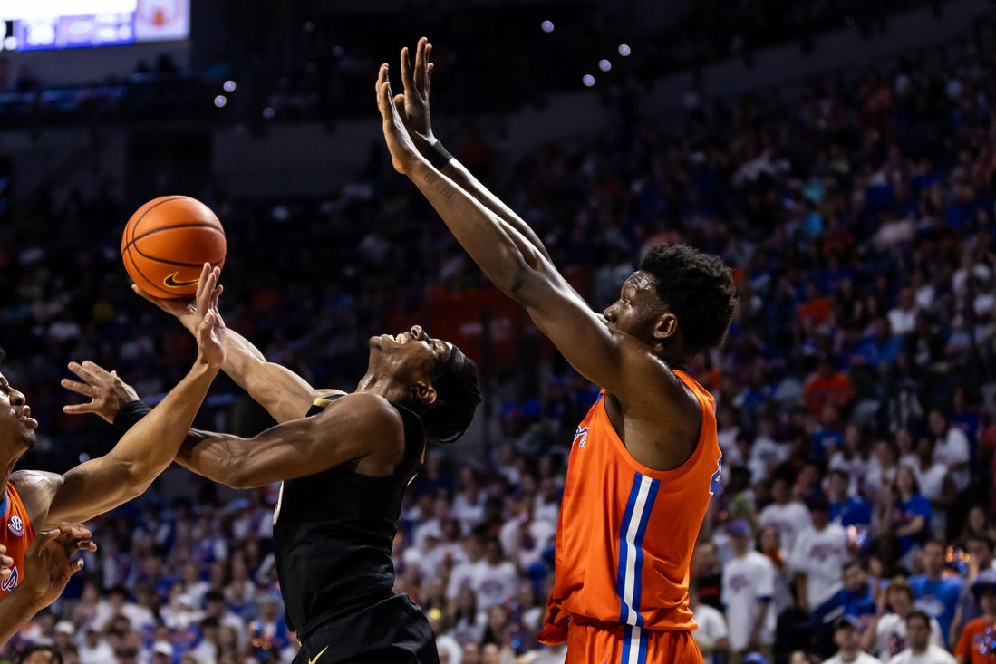 Feb 24, 2024; Gainesville, Florida, USA; Vanderbilt Commodores guard Ezra Manjon (5) attempts a layup over Florida Gators forward Tyrese Samuel (4) during the first half at Exactech Arena at the Stephen C. O'Connell Center. Mandatory Credit: Matt Pendleton-USA TODAY Sports