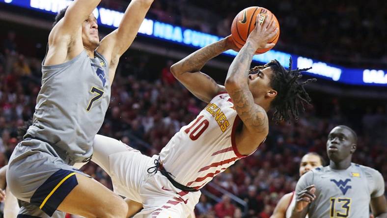 Iowa State Cyclones guard Keshon Gilbert (10) shoots the ball as West Virginia Mountaineers guard Jesse Edwards (7) defends during the first half in the Big-12 conference showdown of a NCAA college basketball at Hilton Coliseum on Feb. x, 2024, in Ames, Iowa.