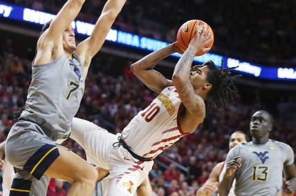 Iowa State Cyclones guard Keshon Gilbert (10) shoots the ball as West Virginia Mountaineers guard Jesse Edwards (7) defends during the first half in the Big-12 conference showdown of a NCAA college basketball at Hilton Coliseum on Feb. x, 2024, in Ames, Iowa.