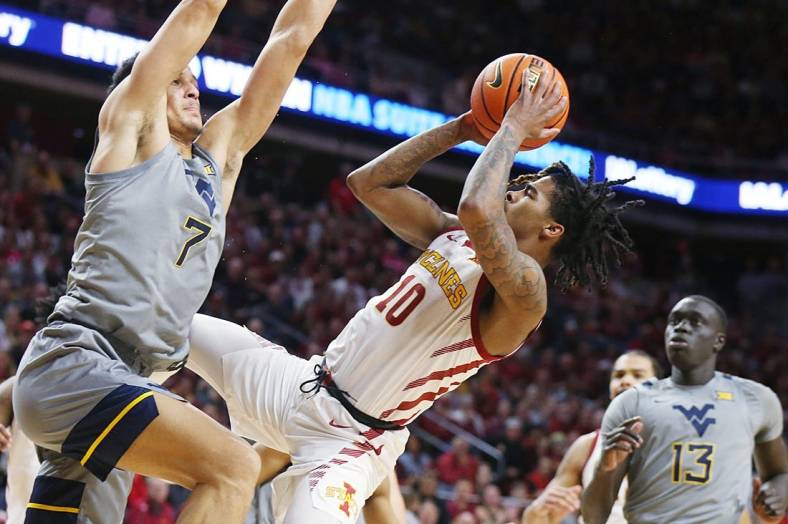 Iowa State Cyclones guard Keshon Gilbert (10) shoots the ball as West Virginia Mountaineers guard Jesse Edwards (7) defends during the first half in the Big-12 conference showdown of a NCAA college basketball at Hilton Coliseum on Feb. x, 2024, in Ames, Iowa.