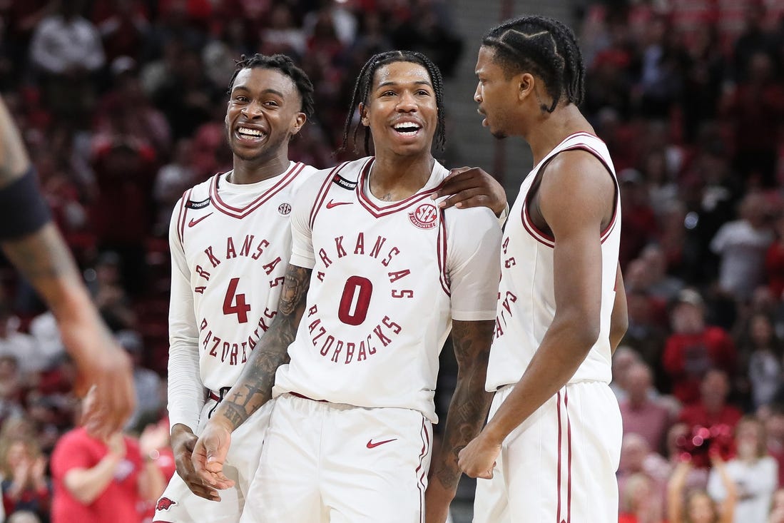 Feb 24, 2024; Fayetteville, Arkansas, USA; Arkansas Razorbacks guard Khalif Battle (0) celebrates with guards Davonte Davis (4) and Tramon Mark (12) after making a three point shot in the second half against the Missouri Tigers at Bud Walton Arena. Arkansas won 88-73. Mandatory Credit: Nelson Chenault-USA TODAY Sports