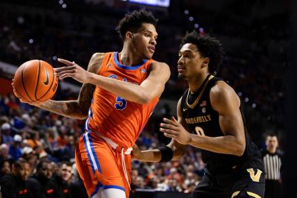 Feb 24, 2024; Gainesville, Florida, USA; Florida Gators guard Will Richard (5) looks to drive at Vanderbilt Commodores guard Tyrin Lawrence (0) during the second half at Exactech Arena at the Stephen C. O'Connell Center. Mandatory Credit: Matt Pendleton-USA TODAY Sports