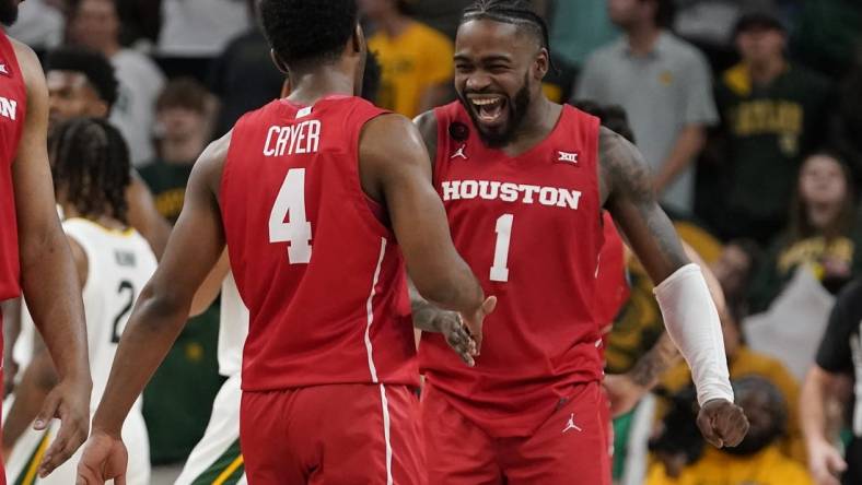 Feb 24, 2024; Waco, Texas, USA; Houston Cougars guard L.J. Cryer (4) and guard Jamal Shead (1) react in the closing moments of overtime against the Baylor Bears at Paul and Alejandra Foster Pavilion. Mandatory Credit: Raymond Carlin III-USA TODAY Sports