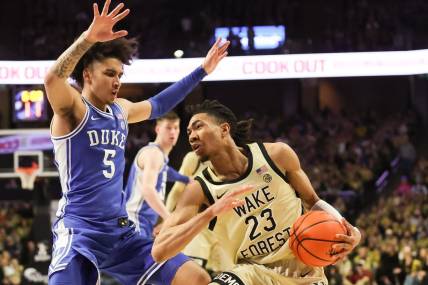 Feb 24, 2024; Winston-Salem, North Carolina, USA;  Wake Forest Demon Deacons guard Hunter Sallis (23) fights for position against Duke Blue Devils guard Tyrese Proctor (5) during the first half at Lawrence Joel Veterans Memorial Coliseum. Mandatory Credit: Cory Knowlton-USA TODAY Sports