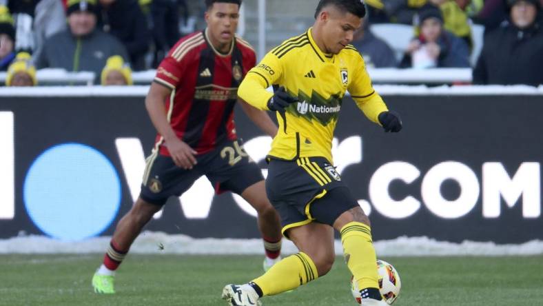 Feb 24, 2024; Columbus, Ohio, USA; Columbus Crew forward Cucho Hernandez (9) dribbles the ball past Atlanta United defender Caleb Wiley (26) during the first half at Lower.com Field. Mandatory Credit: Trevor Ruszkowski-USA TODAY Sports