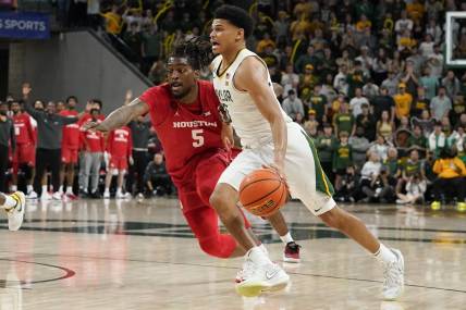 Feb 24, 2024; Waco, Texas, USA; Baylor Bears guard RayJ Dennis (10) works past  Houston Cougars forward Ja'Vier Francis (5) during the second half at Paul and Alejandra Foster Pavilion. Mandatory Credit: Raymond Carlin III-USA TODAY Sports