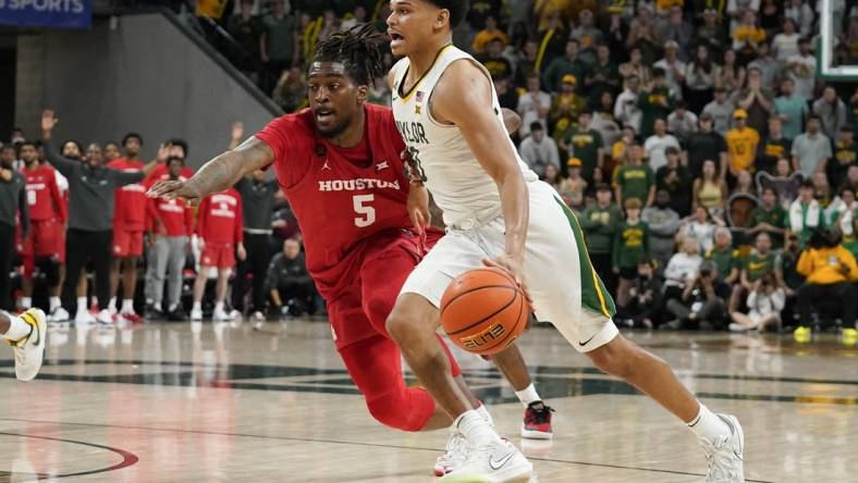 Feb 24, 2024; Waco, Texas, USA; Baylor Bears guard RayJ Dennis (10) works past  Houston Cougars forward Ja'Vier Francis (5) during the second half at Paul and Alejandra Foster Pavilion. Mandatory Credit: Raymond Carlin III-USA TODAY Sports