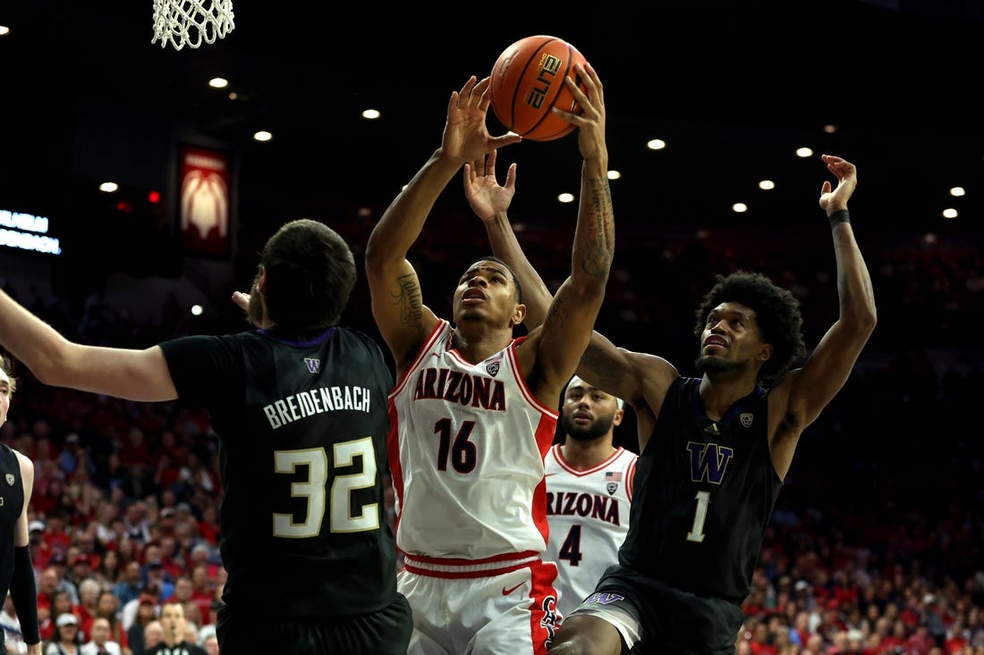 Feb 24, 2024; Tucson, Arizona, USA; Arizona Wildcats forward Keshad Johnson (16) gets a rebound against Washington Huskies forward Wilhelm Breidenbach (32) and forward Keion Brooks Jr. (1) during the second half at McKale Center. Mandatory Credit: Zachary BonDurant-USA TODAY Sports