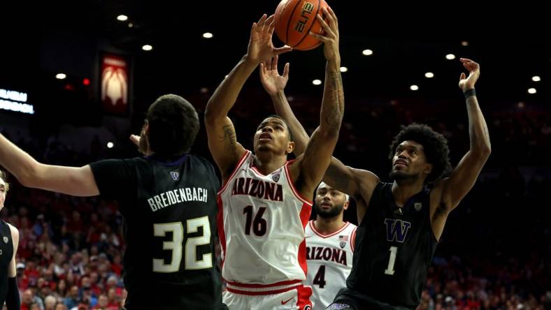 Feb 24, 2024; Tucson, Arizona, USA; Arizona Wildcats forward Keshad Johnson (16) gets a rebound against Washington Huskies forward Wilhelm Breidenbach (32) and forward Keion Brooks Jr. (1) during the second half at McKale Center. Mandatory Credit: Zachary BonDurant-USA TODAY Sports