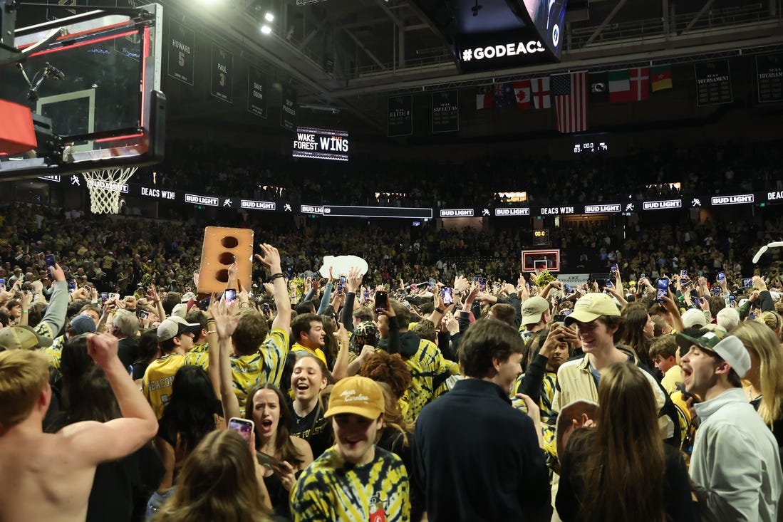 Feb 24, 2024; Winston-Salem, North Carolina, USA;  Wake Forest Demon Deacons students storm the court after Wake Forest wins at Lawrence Joel Veterans Memorial Coliseum. Mandatory Credit: Cory Knowlton-USA TODAY Sports