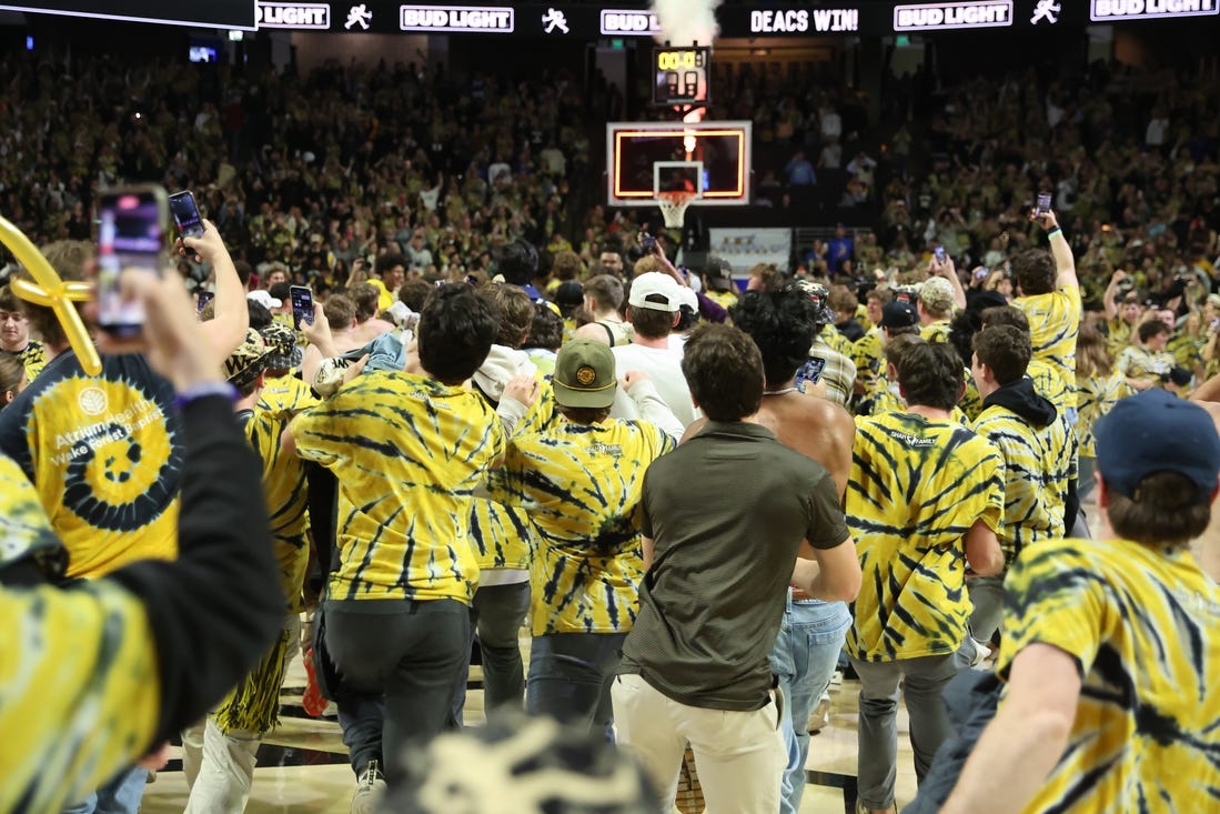 Feb 24, 2024; Winston-Salem, North Carolina, USA;  Wake Forest Demon Deacons students storm the court after Wake Forest wins at Lawrence Joel Veterans Memorial Coliseum. Mandatory Credit: Cory Knowlton-USA TODAY Sports