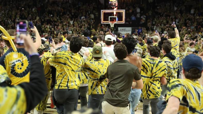 Feb 24, 2024; Winston-Salem, North Carolina, USA;  Wake Forest Demon Deacons students storm the court after Wake Forest wins at Lawrence Joel Veterans Memorial Coliseum. Mandatory Credit: Cory Knowlton-USA TODAY Sports