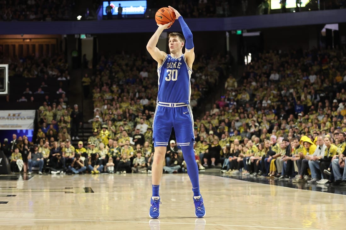 Feb 24, 2024; Winston-Salem, North Carolina, USA;  Duke Blue Devils center Kyle Filipowski (30) makes a three point shot during the second half against the Wake Forest Demon Deacons at Lawrence Joel Veterans Memorial Coliseum. Mandatory Credit: Cory Knowlton-USA TODAY Sports