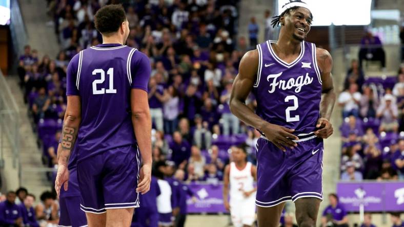 Feb 24, 2024; Fort Worth, Texas, USA; TCU Horned Frogs forward Emanuel Miller (2) celebrates with TCU Horned Frogs forward JaKobe Coles (21) during the second half against the Cincinnati Bearcats at Ed and Rae Schollmaier Arena. Mandatory Credit: Kevin Jairaj-USA TODAY Sports