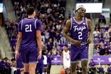 Feb 24, 2024; Fort Worth, Texas, USA; TCU Horned Frogs forward Emanuel Miller (2) celebrates with TCU Horned Frogs forward JaKobe Coles (21) during the second half against the Cincinnati Bearcats at Ed and Rae Schollmaier Arena. Mandatory Credit: Kevin Jairaj-USA TODAY Sports