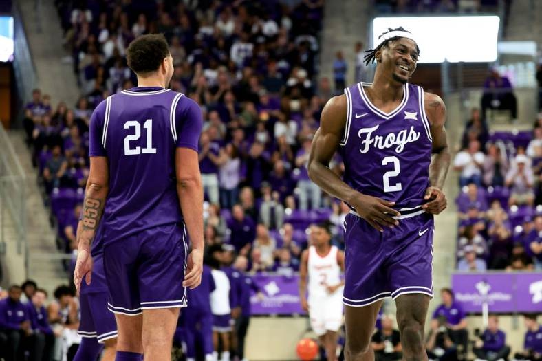 Feb 24, 2024; Fort Worth, Texas, USA; TCU Horned Frogs forward Emanuel Miller (2) celebrates with TCU Horned Frogs forward JaKobe Coles (21) during the second half against the Cincinnati Bearcats at Ed and Rae Schollmaier Arena. Mandatory Credit: Kevin Jairaj-USA TODAY Sports