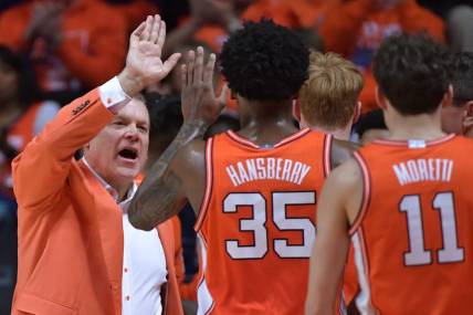 Feb 24, 2024; Champaign, Illinois, USA;  Illinois Fighting Illini head coach Brad Underwood gives players a hand during the second half against the Iowa Hawkeyes at State Farm Center. Mandatory Credit: Ron Johnson-USA TODAY Sports