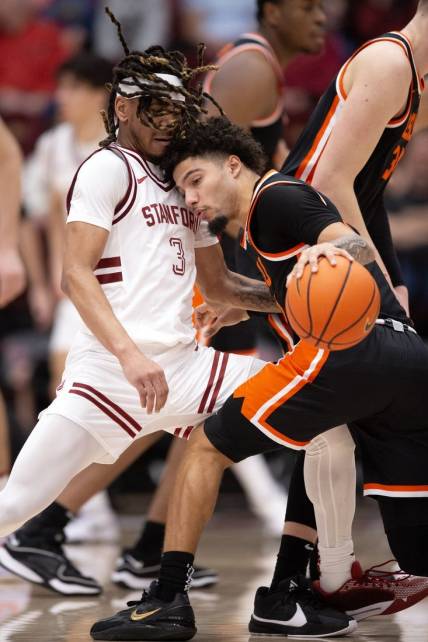 Feb 24, 2024; Stanford, California, USA; Oregon State Beavers guard Jordan Pope (right) collides with Stanford Cardinal guard Kanaan Carlyle (3) during the first half at Maples Pavilion. Mandatory Credit: D. Ross Cameron-USA TODAY Sports