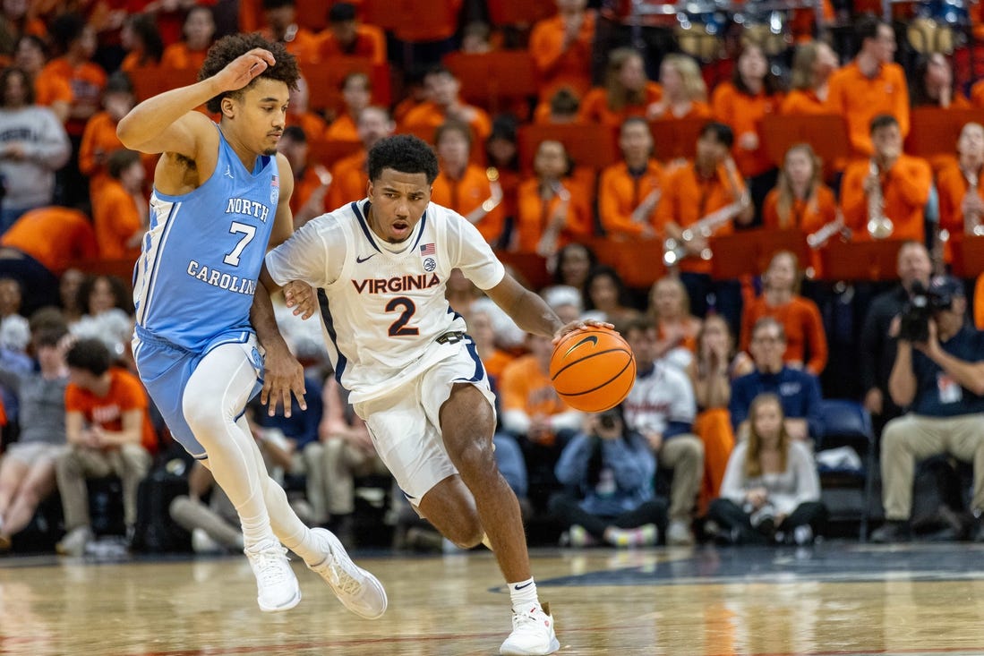 Feb 24, 2024; Charlottesville, Virginia, USA; Virginia Cavaliers guard Reece Beekman (2) drives to the basket while North Carolina Tar Heels guard Seth Trimble (7) defends during the second half at John Paul Jones Arena. Mandatory Credit: Hannah Pajewski-USA TODAY Sports