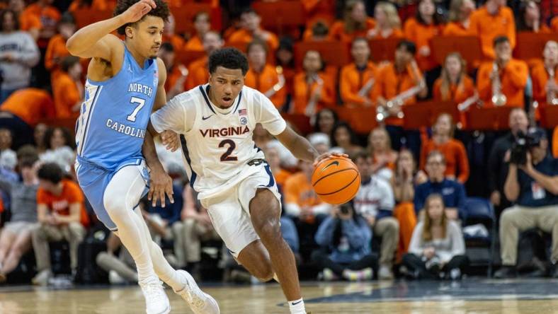 Feb 24, 2024; Charlottesville, Virginia, USA; Virginia Cavaliers guard Reece Beekman (2) drives to the basket while North Carolina Tar Heels guard Seth Trimble (7) defends during the second half at John Paul Jones Arena. Mandatory Credit: Hannah Pajewski-USA TODAY Sports