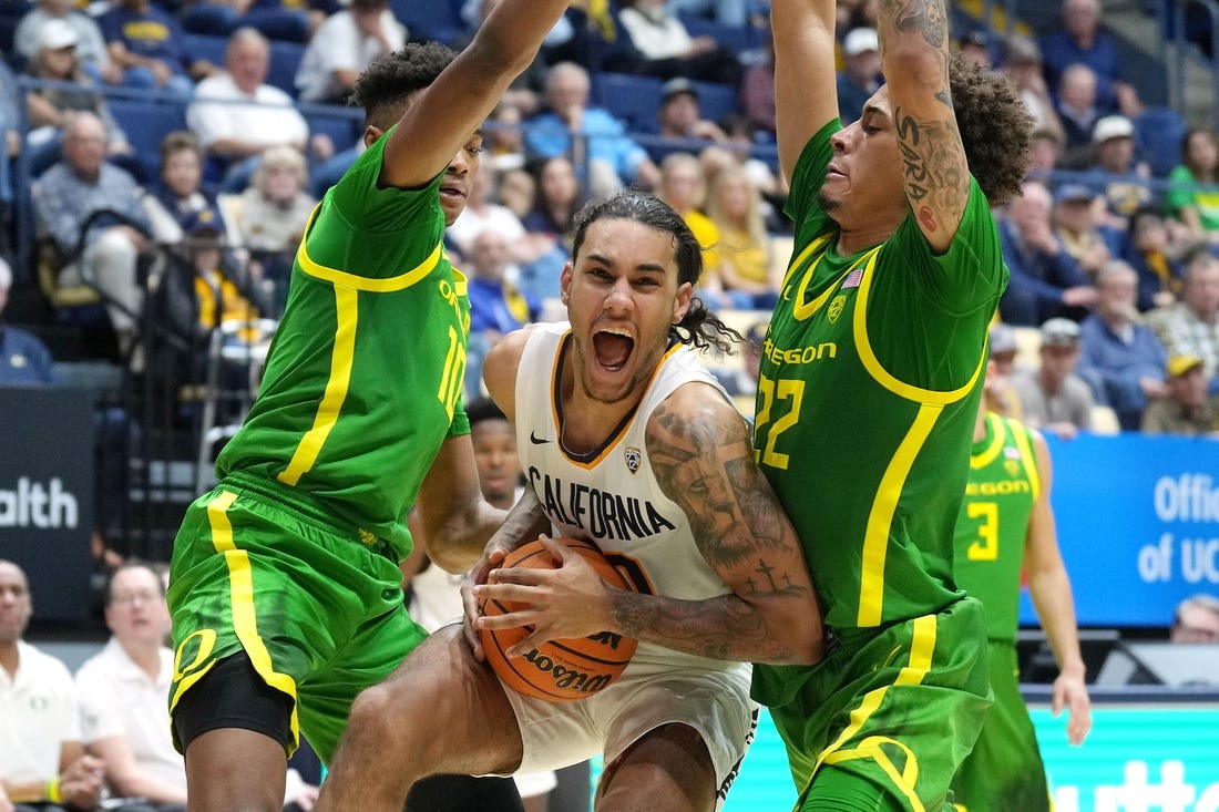 Feb 24, 2024; Berkeley, California, USA; California Golden Bears guard Jaylon Tyson (center) drives against Oregon Ducks forward Kwame Evans Jr. (10) and guard Jadrian Tracey (22) during the first half at Haas Pavilion. Mandatory Credit: Darren Yamashita-USA TODAY Sports