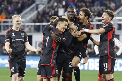 Feb 24, 2024; Washington, District of Columbia, USA; D.C. United forward Christian Benteke (20) celebrates with teammates after scoring a goal against the New England Revolution in the first half at Audi Field. Mandatory Credit: Geoff Burke-USA TODAY Sports