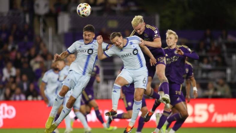 Feb 24, 2024; Orlando, Florida, USA; CF Montreal midfielder Dominic Iankov (8) CF Montreal midfielder Samuel Piette (6) battle Orlando City defender Robin Jansson (6) for the ball in the first half at Inter&Co Stadium. Mandatory Credit: Morgan Tencza-USA TODAY Sports