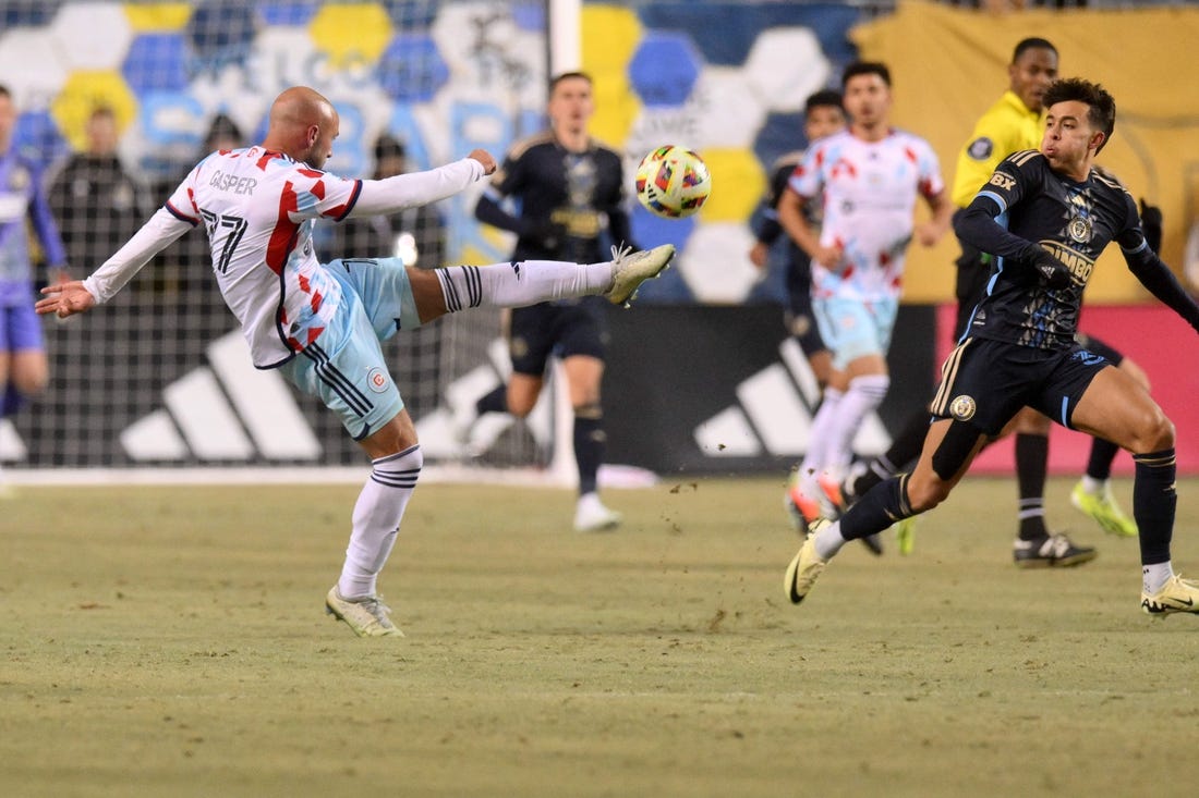 Feb 24, 2024; Philadelphia, Pennsylvania, USA; Chicago Fire FC defender Chase Gasper (77) kicks the ball against the Philadelphia Union during the first half at Subaru Park. Mandatory Credit: John Jones-USA TODAY Sports