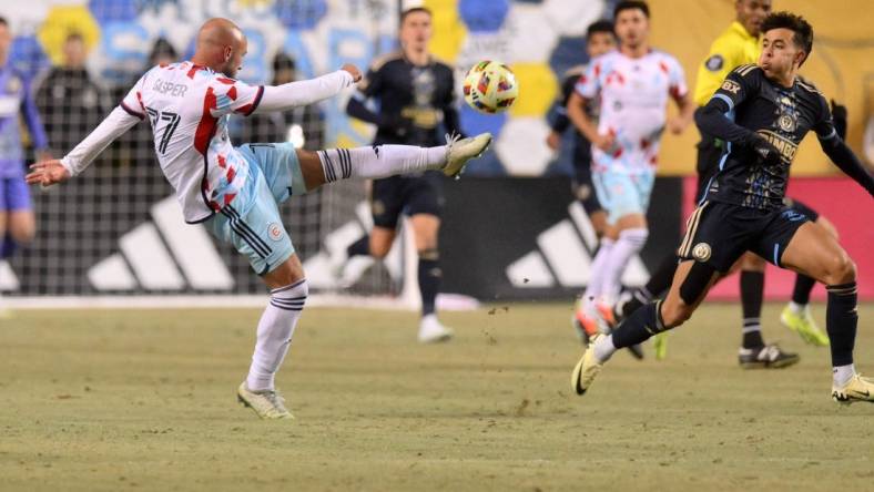 Feb 24, 2024; Philadelphia, Pennsylvania, USA; Chicago Fire FC defender Chase Gasper (77) kicks the ball against the Philadelphia Union during the first half at Subaru Park. Mandatory Credit: John Jones-USA TODAY Sports