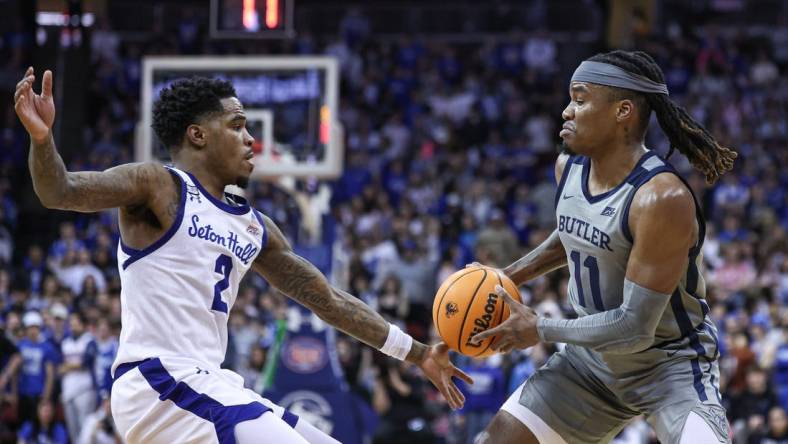 Feb 24, 2024; Newark, New Jersey, USA; Butler Bulldogs guard Jahmyl Telfort (11) looks to pass was Seton Hall Pirates guard Al-Amir Dawes (2) defends during the first half at Prudential Center. Mandatory Credit: Vincent Carchietta-USA TODAY Sports