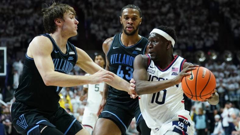 Feb 24, 2024; Storrs, Connecticut, USA; UConn Huskies guard Hassan Diarra (10) drives the ball against Villanova Wildcats forward Eric Dixon (43) and guard Brendan Hausen (1) in the second half at Harry A. Gampel Pavilion. Mandatory Credit: David Butler II-USA TODAY Sports