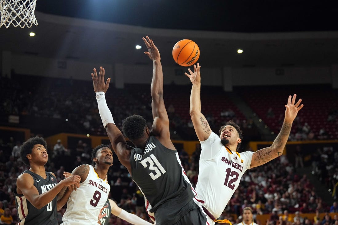 Feb 24, 2024; Tempe, Arizona, USA; Arizona State Sun Devils guard Jose Perez (12) shoots over Washington State Cougars guard Kymany Houinsou (31) during the second half at Desert Financial Arena. Mandatory Credit: Joe Camporeale-USA TODAY Sports