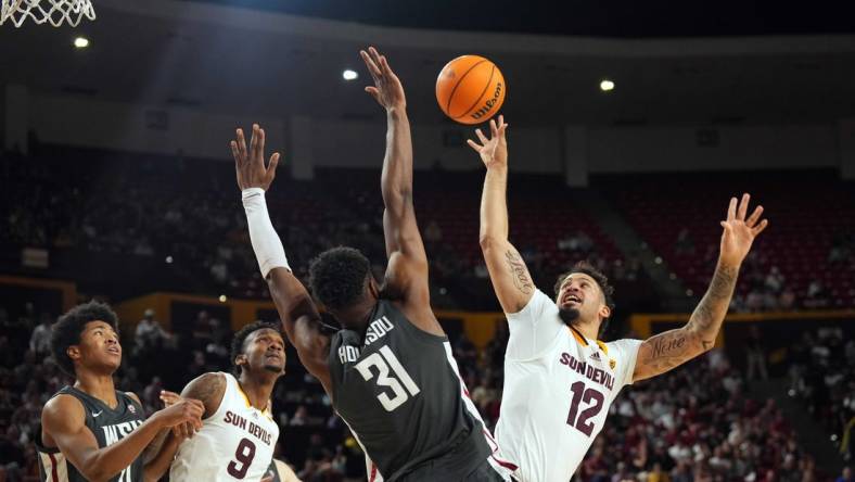 Feb 24, 2024; Tempe, Arizona, USA; Arizona State Sun Devils guard Jose Perez (12) shoots over Washington State Cougars guard Kymany Houinsou (31) during the second half at Desert Financial Arena. Mandatory Credit: Joe Camporeale-USA TODAY Sports