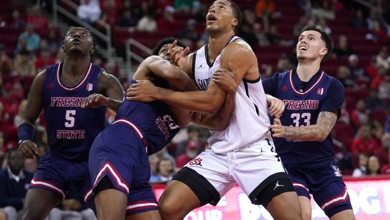 Feb 24, 2024; Fresno, California, USA; San Diego State Aztecs forward Jaedon LeDee (13) battles for position with Fresno State Bulldogs guard Leo Colimerio (23) and guard Steven Vasquez Jr. (33) in the first half at the Save Mart Center. Mandatory Credit: Cary Edmondson-USA TODAY Sports