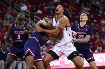 Feb 24, 2024; Fresno, California, USA; San Diego State Aztecs forward Jaedon LeDee (13) battles for position with Fresno State Bulldogs guard Leo Colimerio (23) and guard Steven Vasquez Jr. (33) in the first half at the Save Mart Center. Mandatory Credit: Cary Edmondson-USA TODAY Sports
