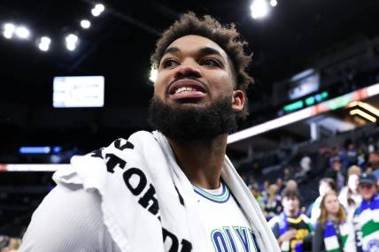 Feb 24, 2024; Minneapolis, Minnesota, USA; Minnesota Timberwolves center Karl-Anthony Towns (32) reacts to the team   s win against the Brooklyn Nets after the game at Target Center. Mandatory Credit: Matt Krohn-USA TODAY Sports