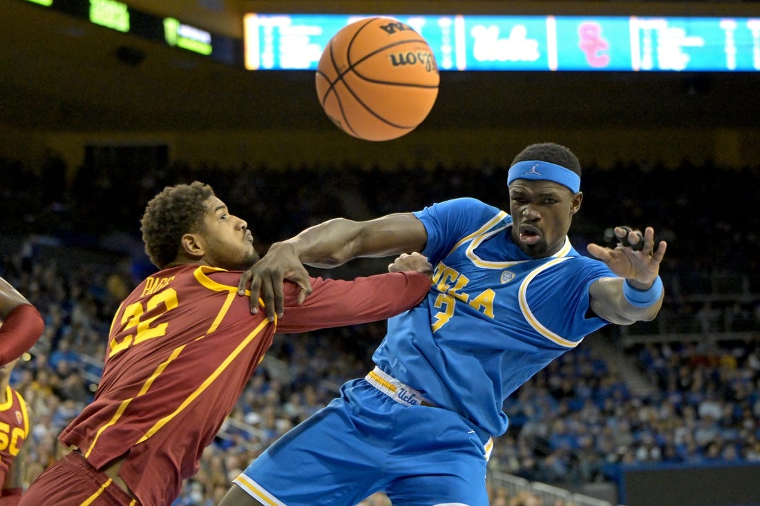 Feb 24, 2024; Los Angeles, California, USA;  USC Trojans forward Arrinten Page (22) and UCLA Bruins forward Adem Bona (3) go for a rebound in the first half at Pauley Pavilion presented by Wescom. Mandatory Credit: Jayne Kamin-Oncea-USA TODAY Sports