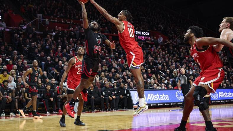 Feb 25, 2024; Piscataway, New Jersey, USA; Maryland Terrapins forward Julian Reese (10) blocks a shot by Rutgers Scarlet Knights guard Austin Williams (24) during the second half at Jersey Mike's Arena. Mandatory Credit: Vincent Carchietta-USA TODAY Sports