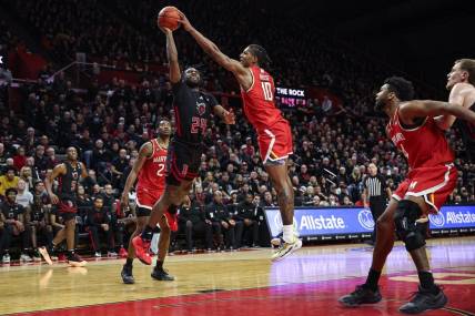 Feb 25, 2024; Piscataway, New Jersey, USA; Maryland Terrapins forward Julian Reese (10) blocks a shot by Rutgers Scarlet Knights guard Austin Williams (24) during the second half at Jersey Mike's Arena. Mandatory Credit: Vincent Carchietta-USA TODAY Sports