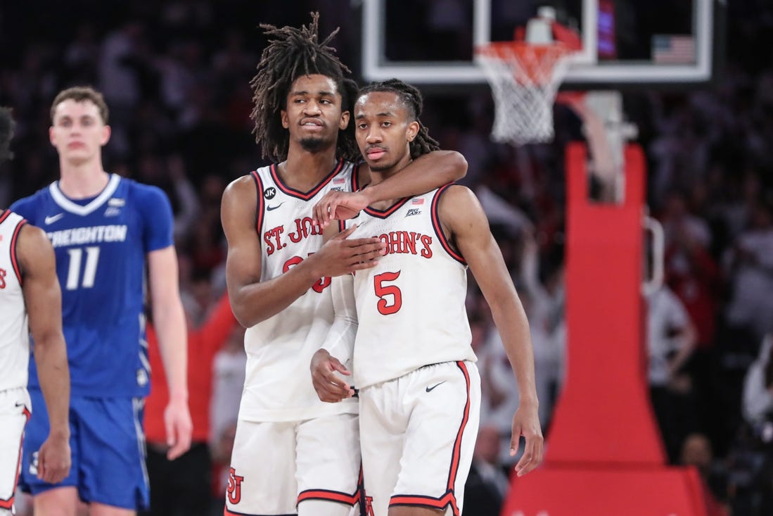 Feb 25, 2024; New York, New York, USA;  St. John's Red Storm forward Glenn Taylor Jr. (35) hugs guard Daniss Jenkins (5) in the second half against the Creighton Bluejays at Madison Square Garden. Mandatory Credit: Wendell Cruz-USA TODAY Sports