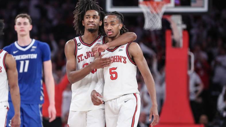 Feb 25, 2024; New York, New York, USA;  St. John's Red Storm forward Glenn Taylor Jr. (35) hugs guard Daniss Jenkins (5) in the second half against the Creighton Bluejays at Madison Square Garden. Mandatory Credit: Wendell Cruz-USA TODAY Sports